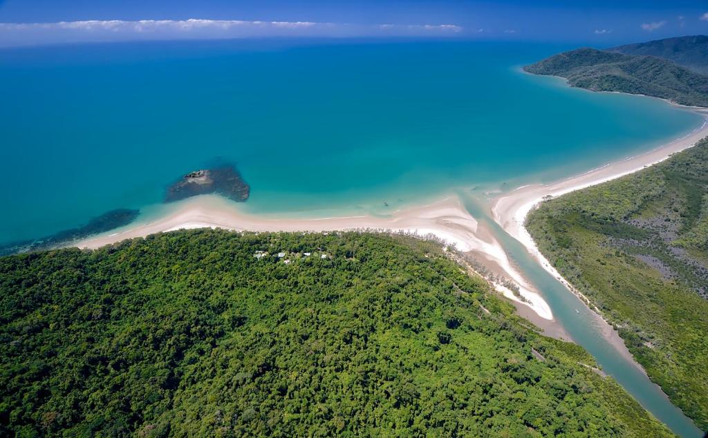 a view from the top of a mountain of the ocean at Thornton Beach Bungalows Daintree in Cape Tribulation