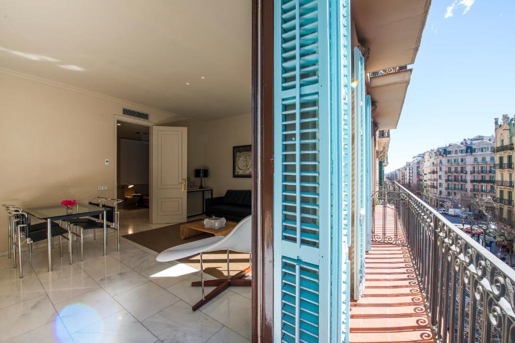 a room with a balcony with a view of a city at Glocal Apartments Barcelona in Barcelona