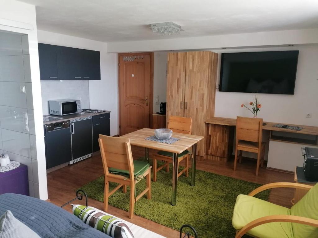 een keuken en eetkamer met een tafel en stoelen bij Hausblick Matt, Lochau in Lochau