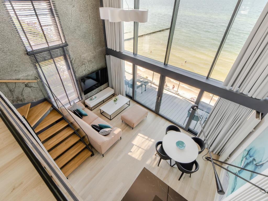 an overhead view of a living room with a view of the ocean at Sailor - Apartament MIRAMAR in Ustronie Morskie