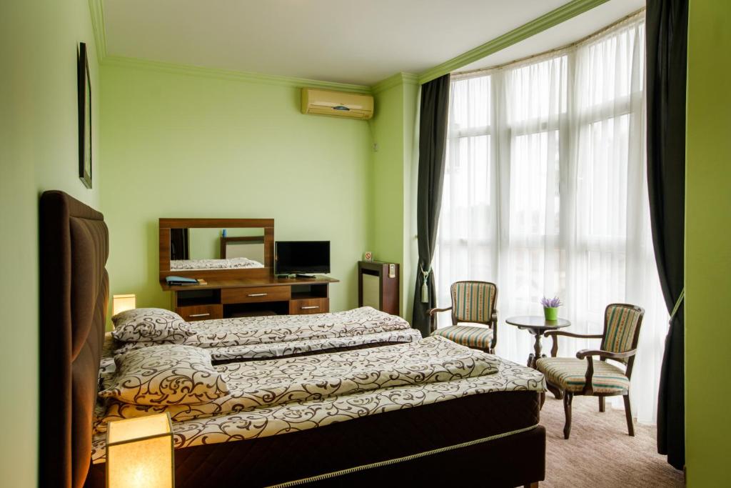 Postel nebo postele na pokoji v ubytování Villa Modena