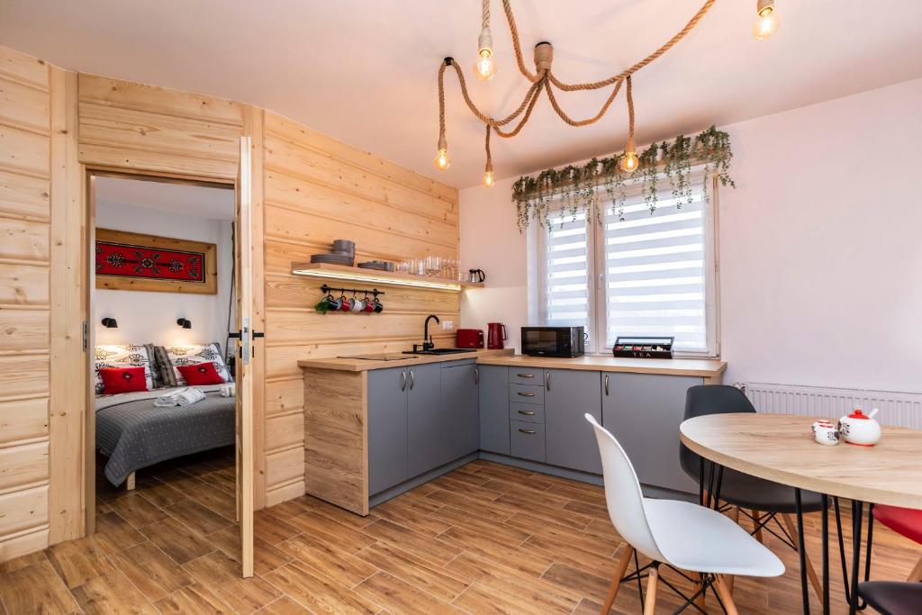 eine Küche und ein Esszimmer mit einem Tisch und Stühlen in der Unterkunft Apartament Hanki przy Krupówkach in Zakopane