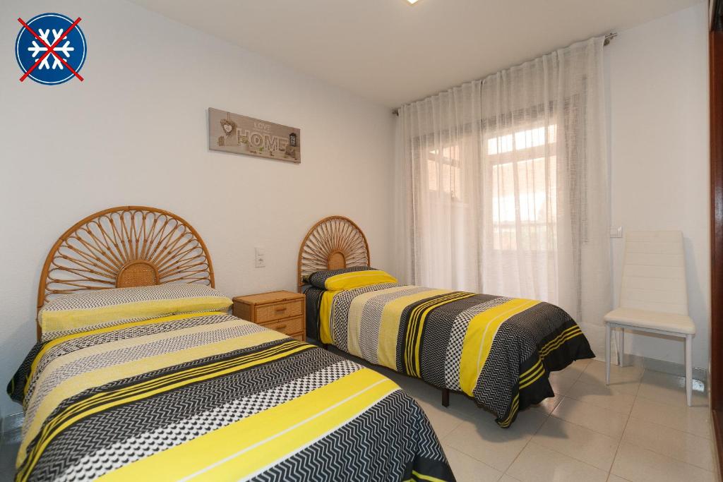 Łóżko lub łóżka w pokoju w obiekcie UHC STELLA MARIS APARTMENTS
