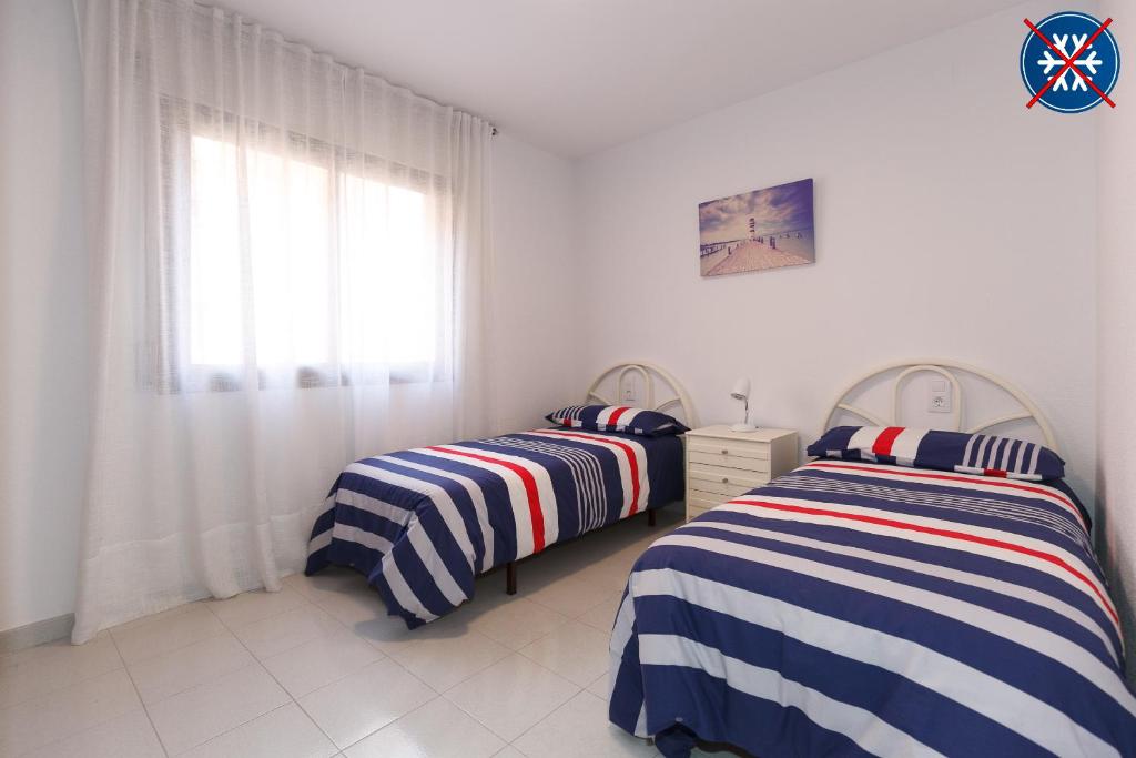 Łóżko lub łóżka w pokoju w obiekcie UHC STELLA MARIS APARTMENTS