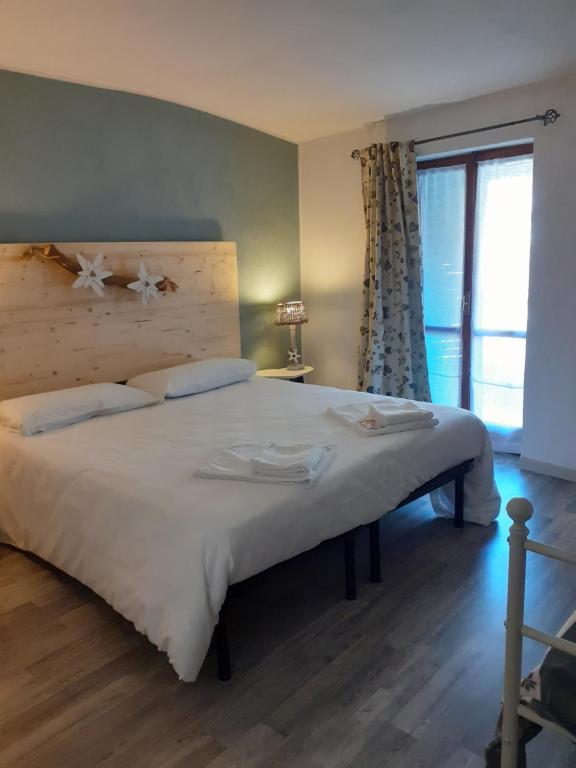 Postel nebo postele na pokoji v ubytování La Casetta Del Dahu