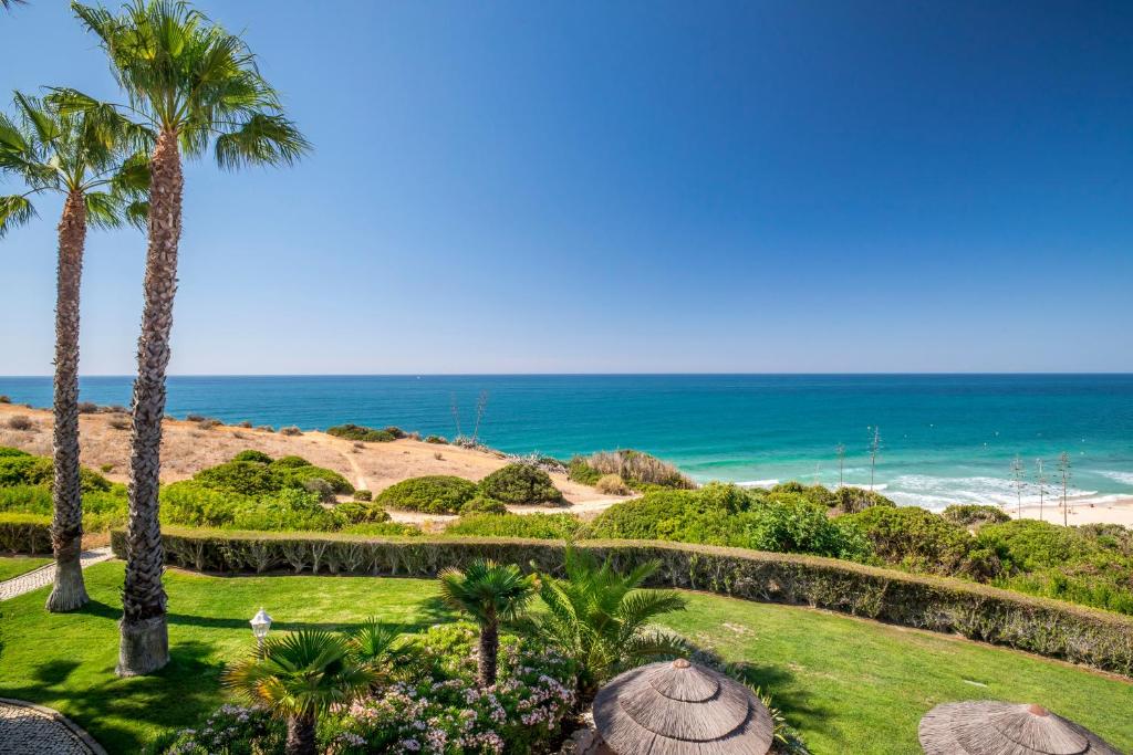 a view of the beach from a resort with palm trees at Clube Porto Mos - Sunplace Hotels & Beach Resort in Lagos