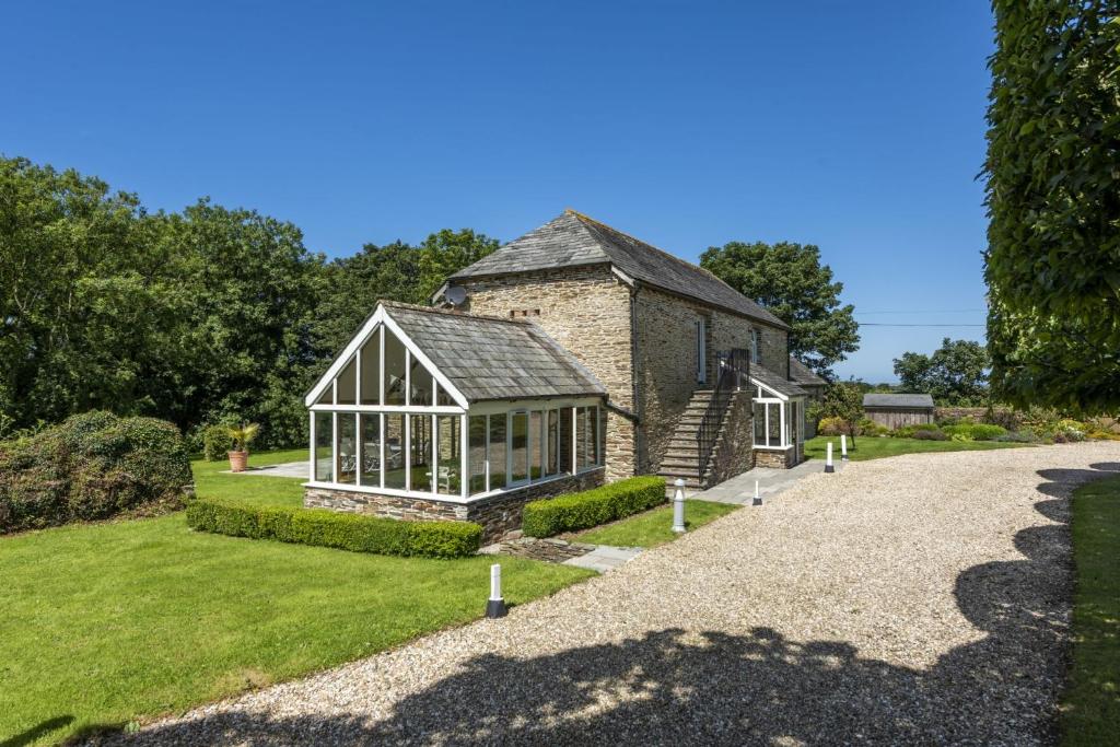 an external view of a house with a conservatory at Mowhay Barn in Padstow