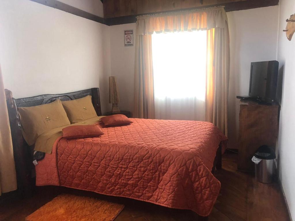Postel nebo postele na pokoji v ubytování Hosteria San Jose de Sigchos