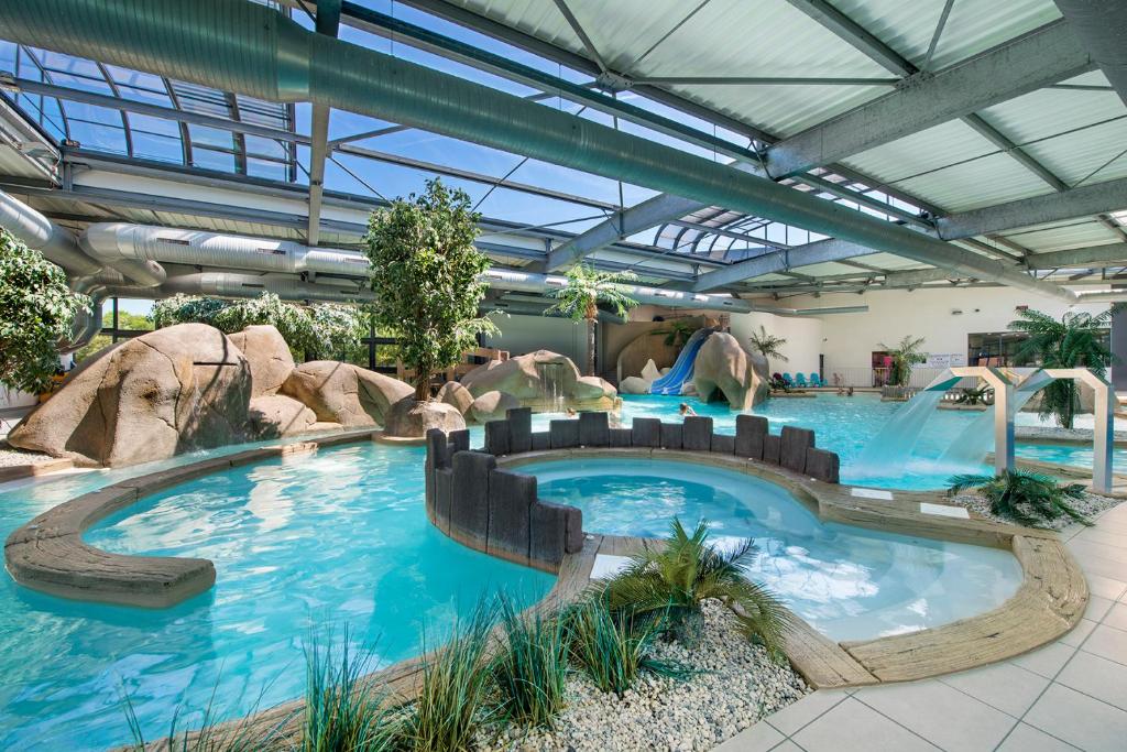 une grande piscine dans un parc aquatique dans l'établissement Camping L'Ocean, à Brem-sur-Mer