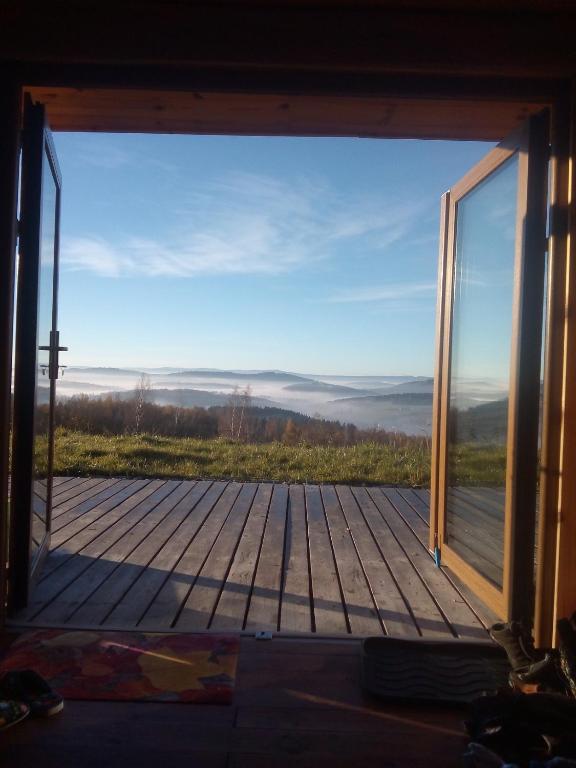 a view from the inside of a room with a large window at Jugowskie Chatki in Jugów