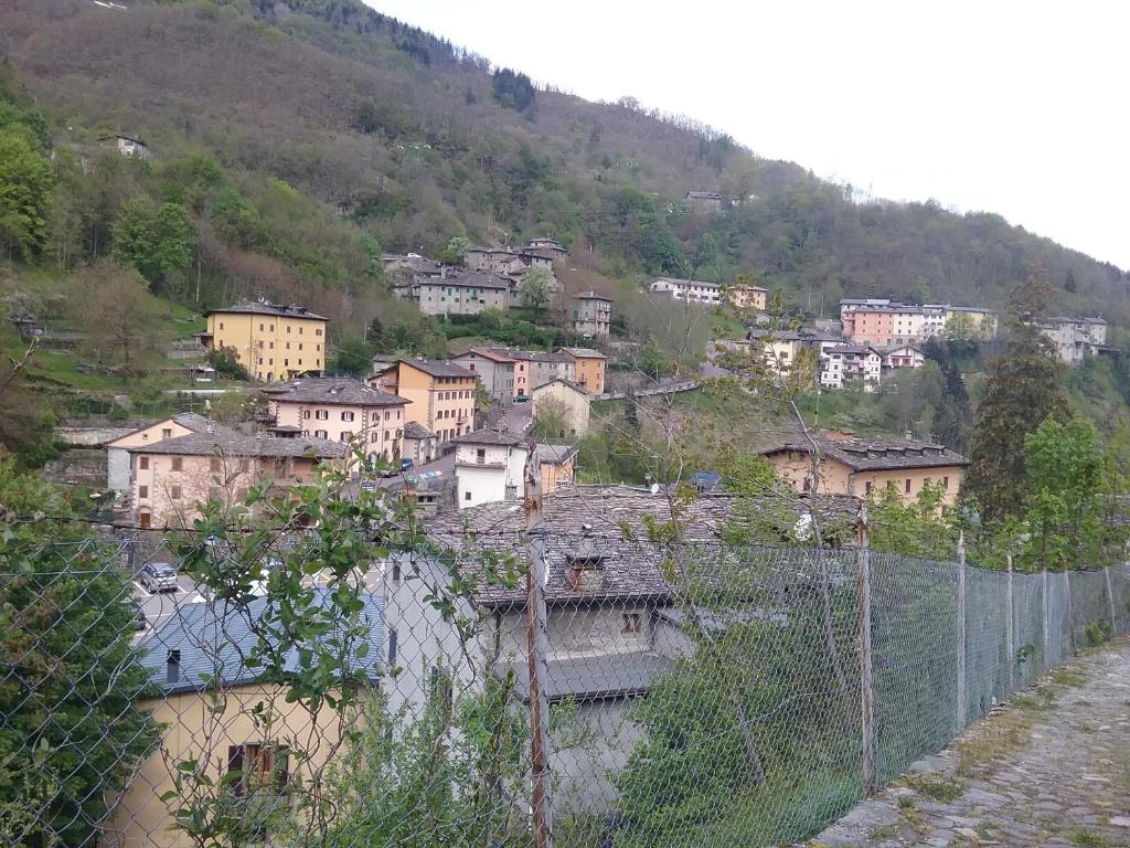 a village on the side of a hill with a fence at Fenecchio in Fiumalbo