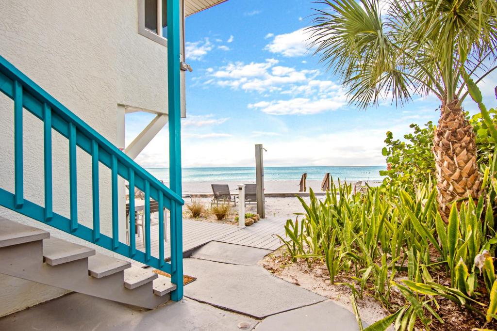 a staircase leading to the beach from a house at Island House in Englewood