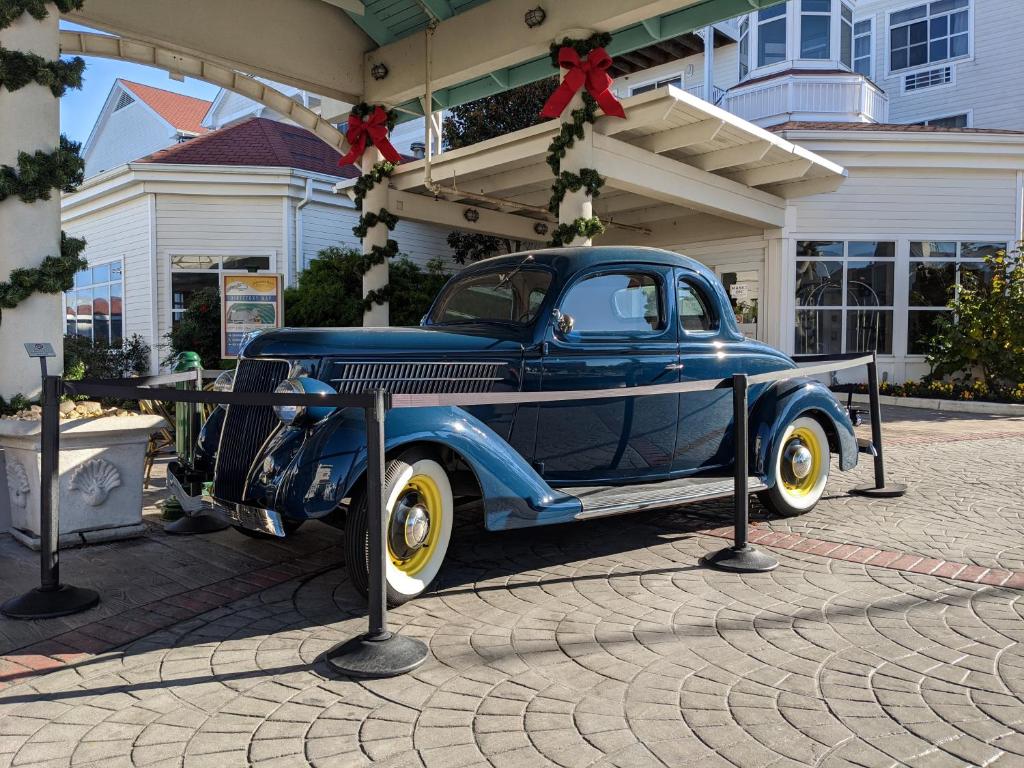 an old blue car parked in front of a house at Rod 'N' Reel Resort in Chesapeake Beach