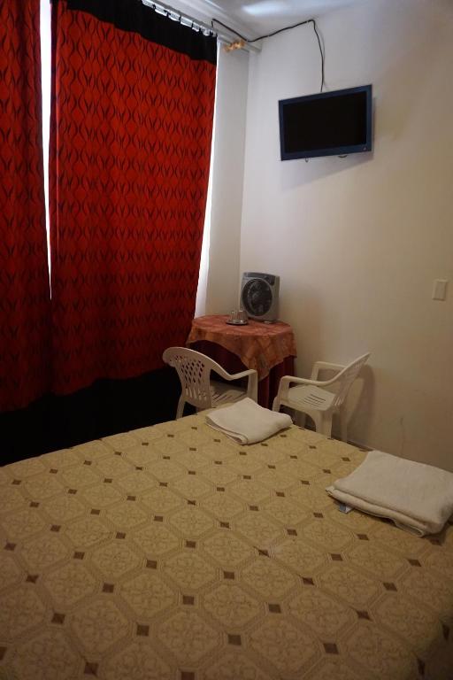 Postel nebo postele na pokoji v ubytování Hostal Camiluz