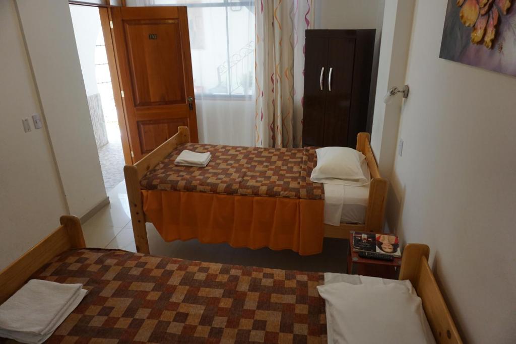 Postel nebo postele na pokoji v ubytování Hostal Camiluz