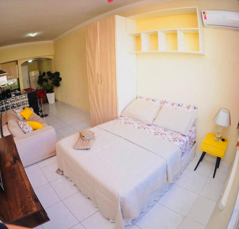 a bedroom with a large bed and a couch at Vista Mar Luxo Copacabana in Rio de Janeiro