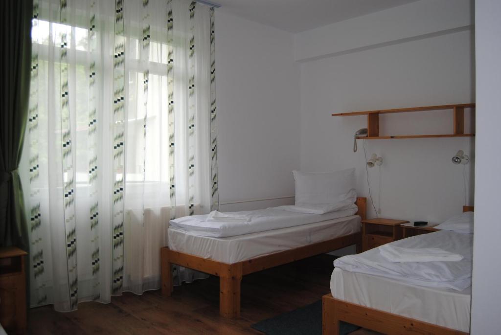 Postel nebo postele na pokoji v ubytování Hostel Teleki