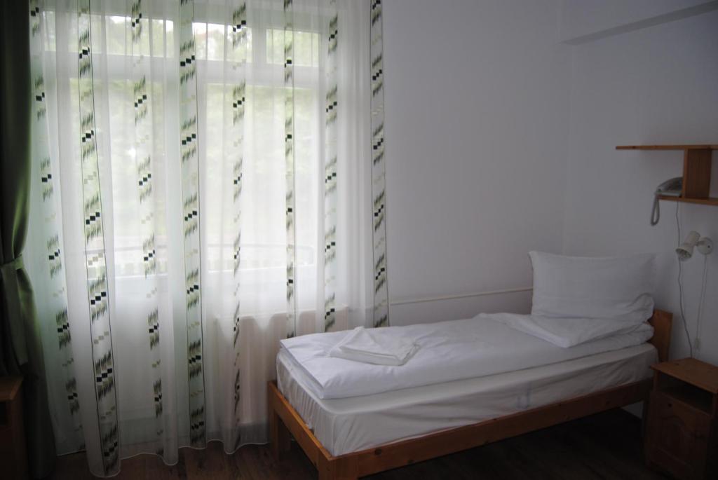Postel nebo postele na pokoji v ubytování Hostel Teleki