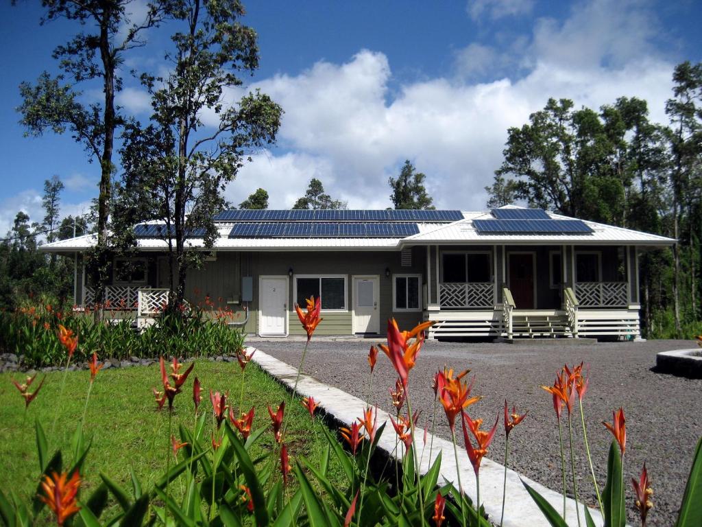 a house with solar panels on the roof at Keaau Place in Keaau
