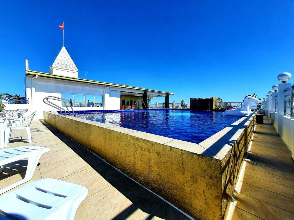 a swimming pool on the roof of a building at Kandi Palace in Angeles