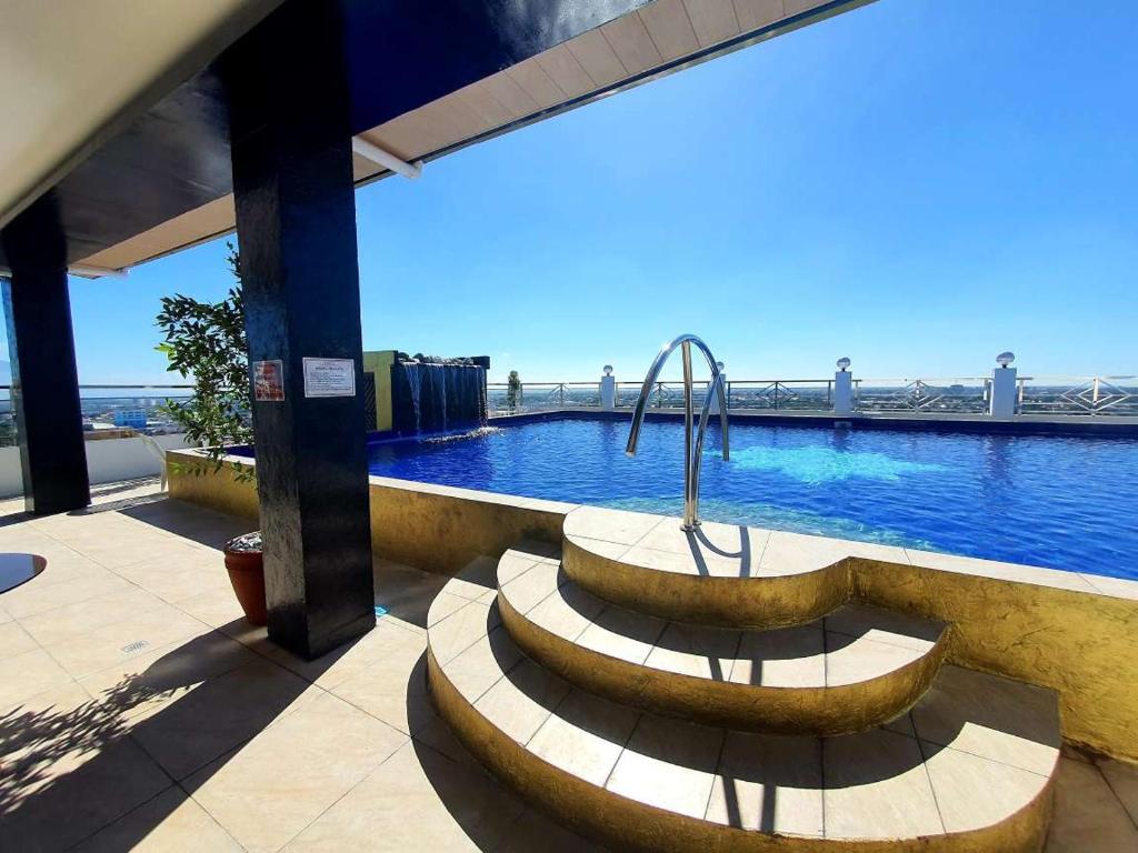a pool with a fountain in the middle of a building at Kandi Palace in Angeles
