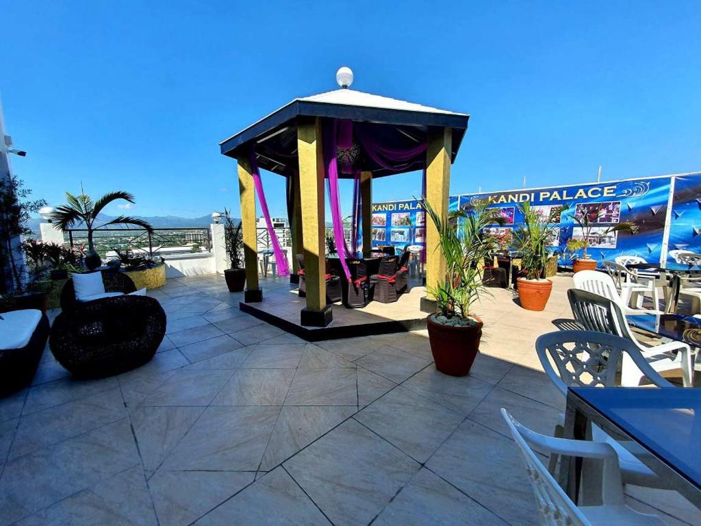 a gazebo with chairs and tables on a patio at Kandi Palace in Angeles