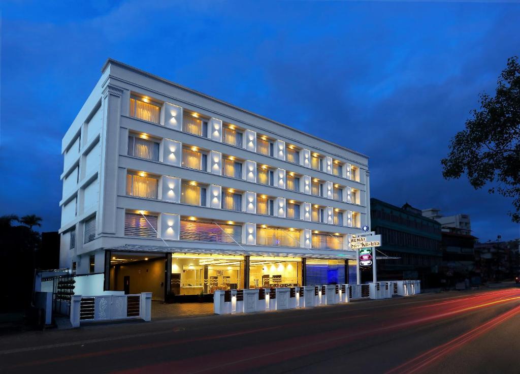 a large white building on the side of a street at Renai Sreekrishna in Guruvāyūr
