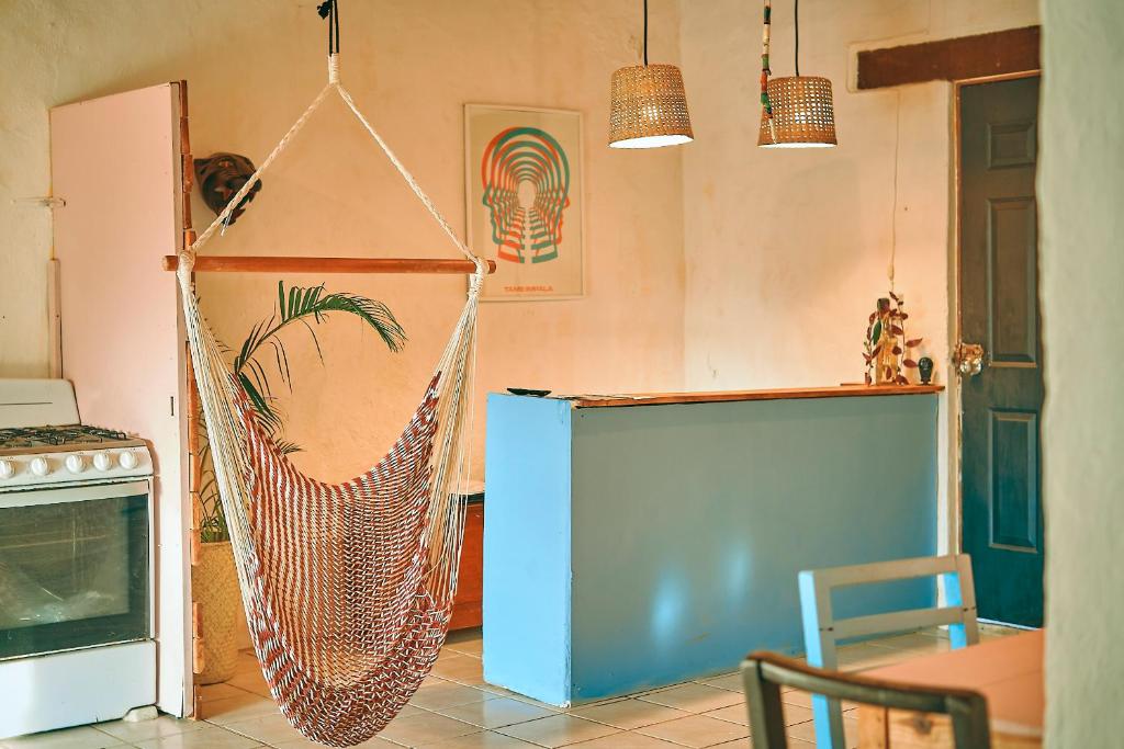 a kitchen with a hammock in a room at Blue Pepper Beds Sayulita in Sayulita