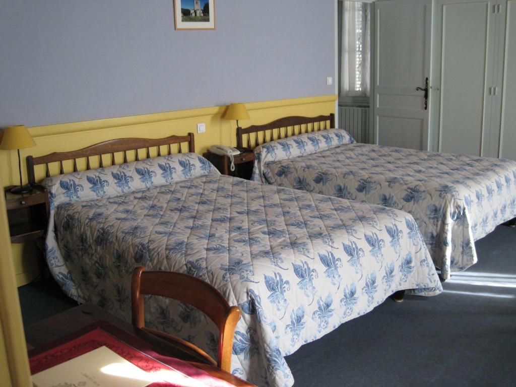 Postel nebo postele na pokoji v ubytování Hôtel Colombet