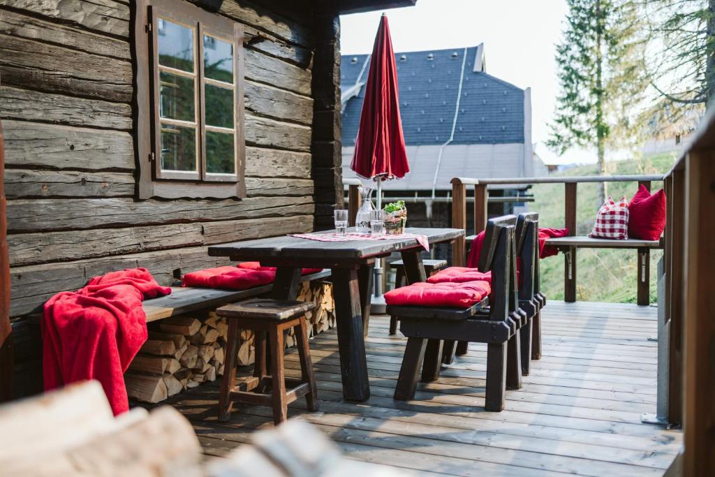 a wooden deck with a table and chairs on a cabin at Apartment HOT CHILI in Hermagor