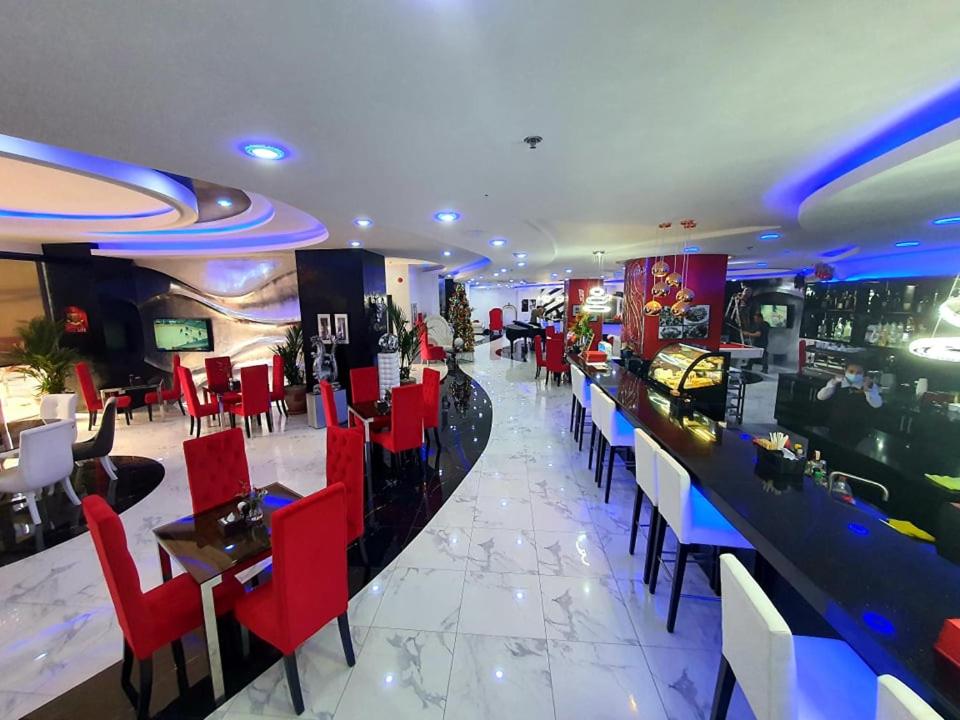 a restaurant with red chairs and a bar at Kandi Palace in Angeles