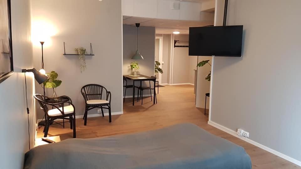 a room with a bed and a table and chairs at Apartments Uppsala - Portalgatan in Uppsala