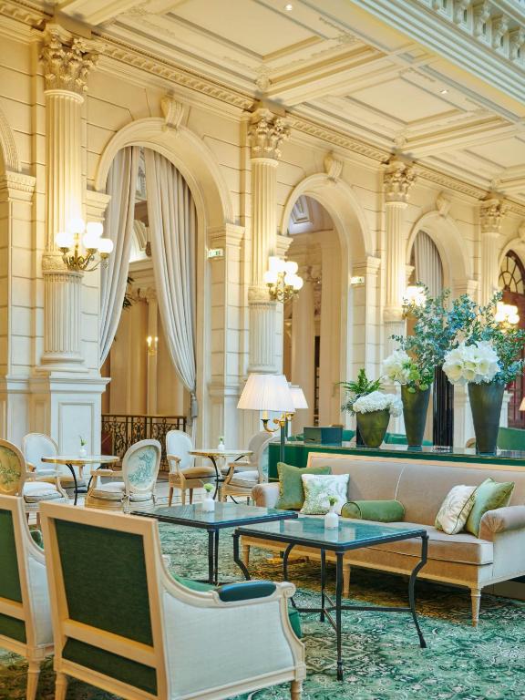 a lobby with a couch and tables and chairs at InterContinental Paris Le Grand by IHG in Paris