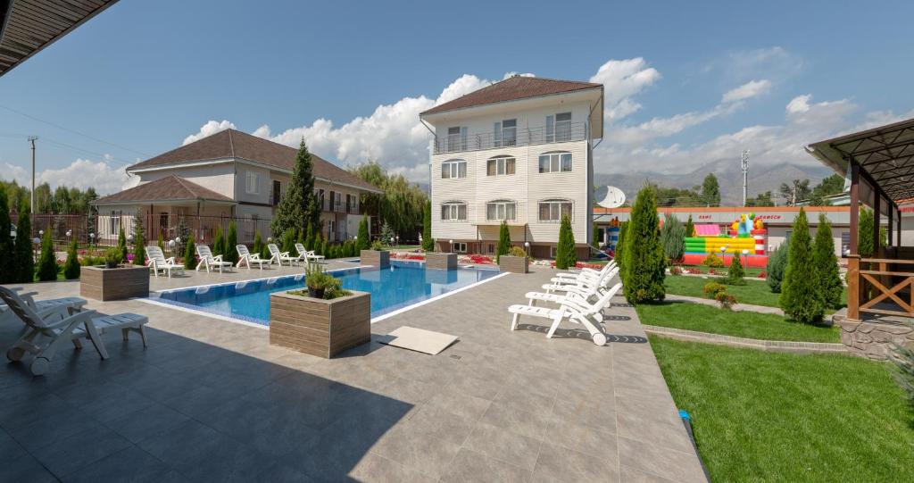 a villa with a swimming pool and a house at Арт-отель ololoFamily in Chon-Sary-Oy