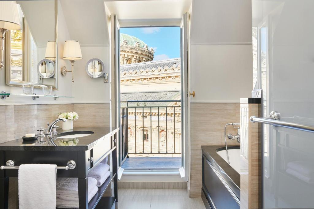 a bathroom with a view of the eiffel tower at InterContinental Paris Le Grand by IHG in Paris