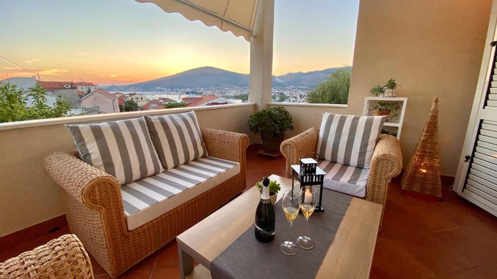 a balcony with two chairs and a table with a view at Trogir center exclusive seaview apartment for 4 in Trogir