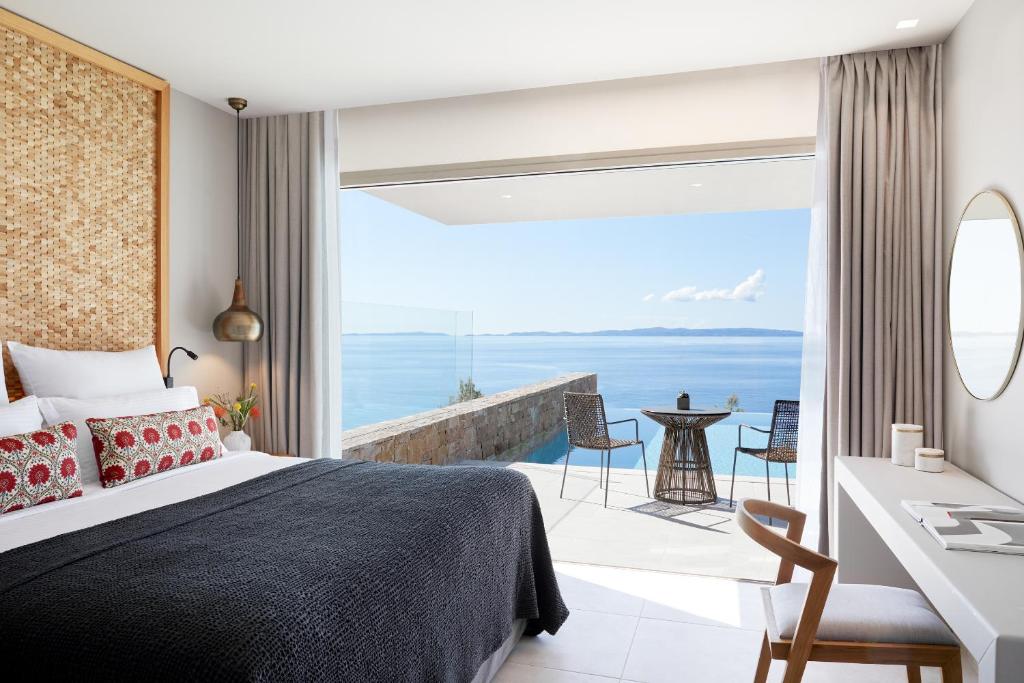a bedroom with a bed and a view of the ocean at Elix, Mar-Bella Collection in Perdika