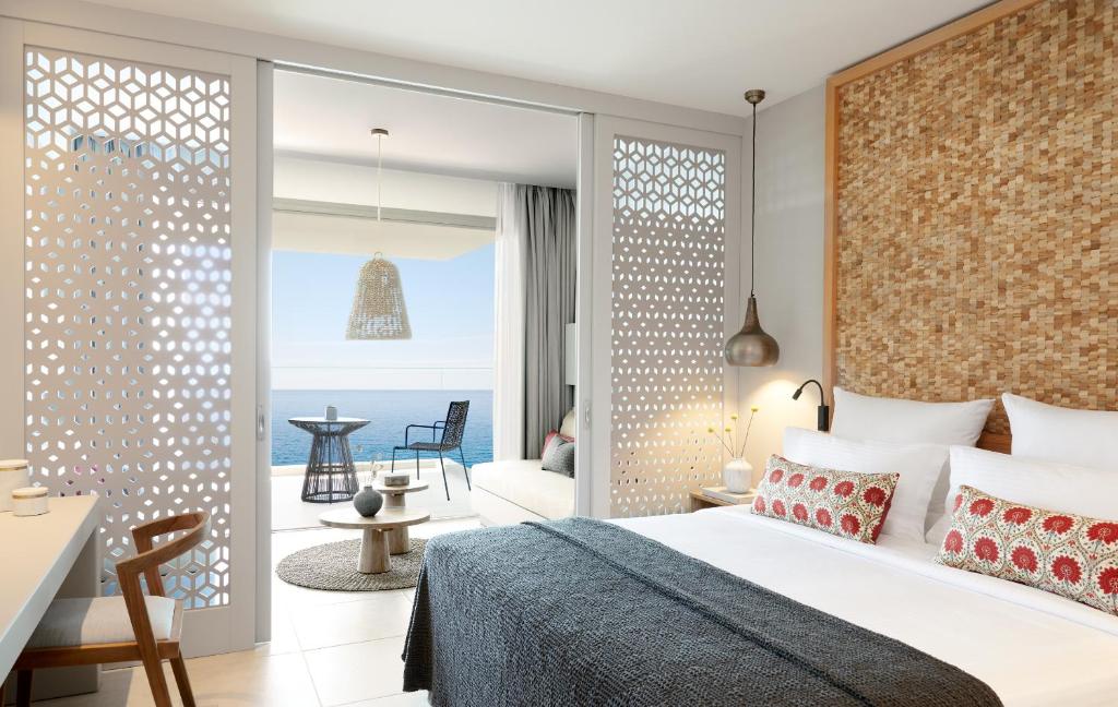 a bedroom with a bed and a view of the ocean at Elix, Mar-Bella Collection in Perdika