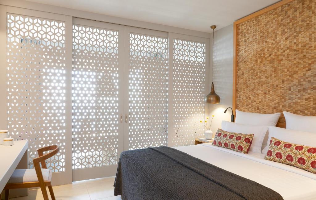 a bedroom with a bed and a large window at Elix, Mar-Bella Collection in Perdika