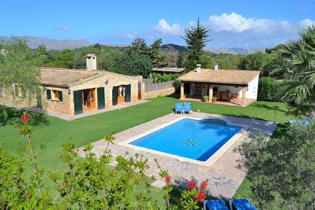 an external view of a house with a swimming pool at 041 Finca Can Roig Gran ET0309 by Mallorca Charme in Pollença