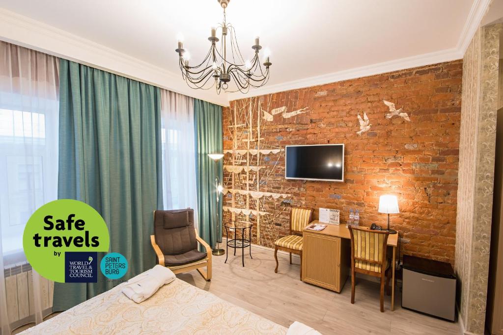 a hotel room with a brick accent wall at Hotel 1913 year in Saint Petersburg