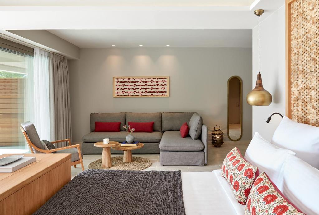 a living room with a couch and a table at Elix, Mar-Bella Collection in Perdika