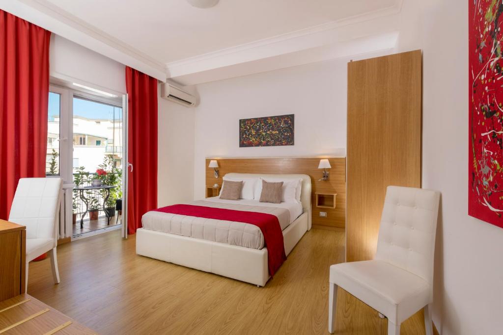 a hotel room with a bed and a chair at Aurelia 429 Fine Town House in Rome