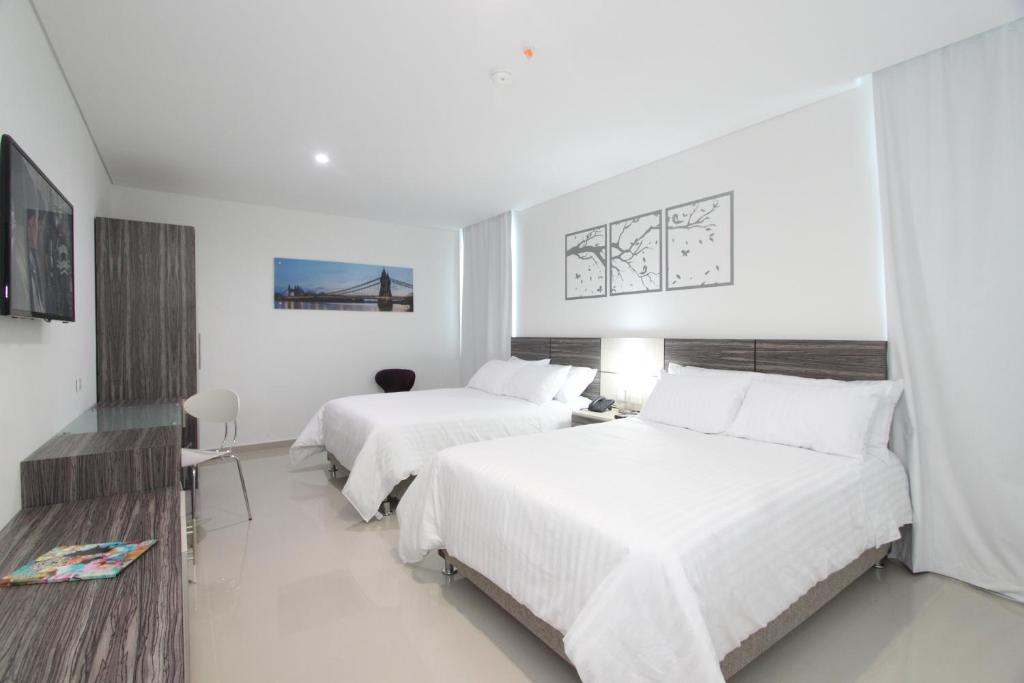 Postel nebo postele na pokoji v ubytování Hotel Oxford Barranquilla