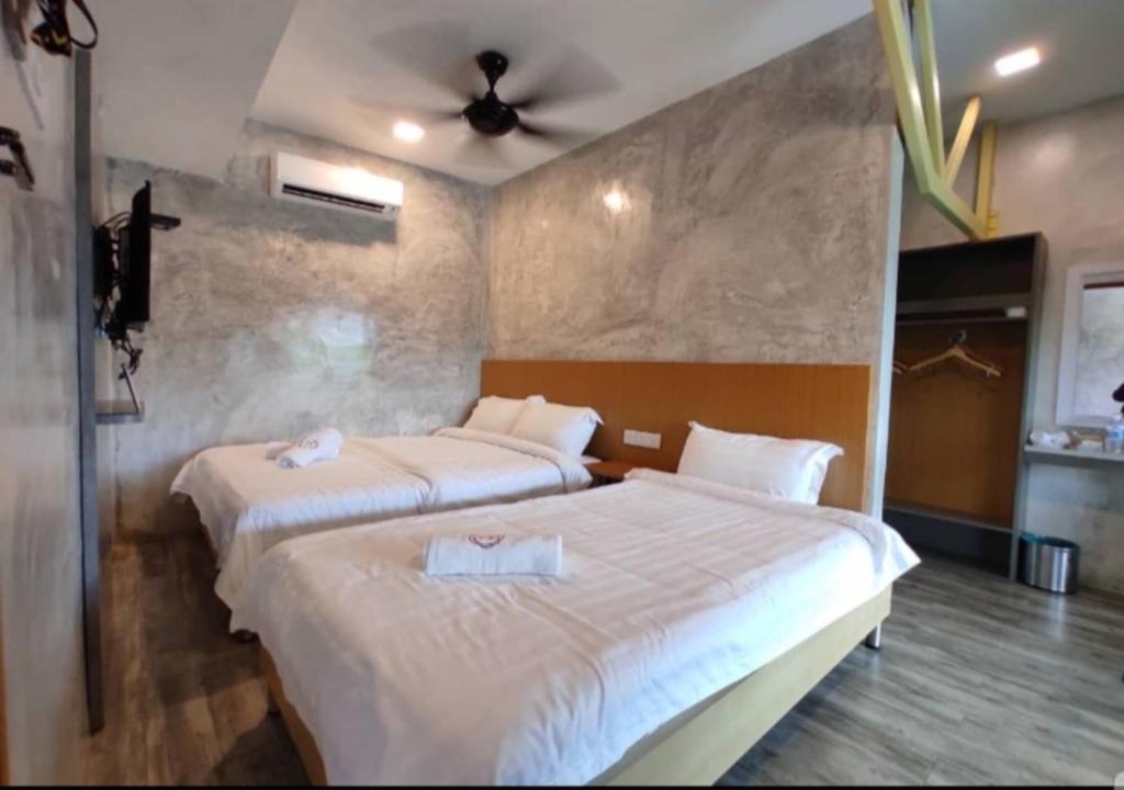 Postel nebo postele na pokoji v ubytování Rick Resort Teluk Intan