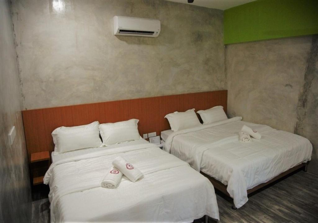 Postel nebo postele na pokoji v ubytování Rick Resort Teluk Intan