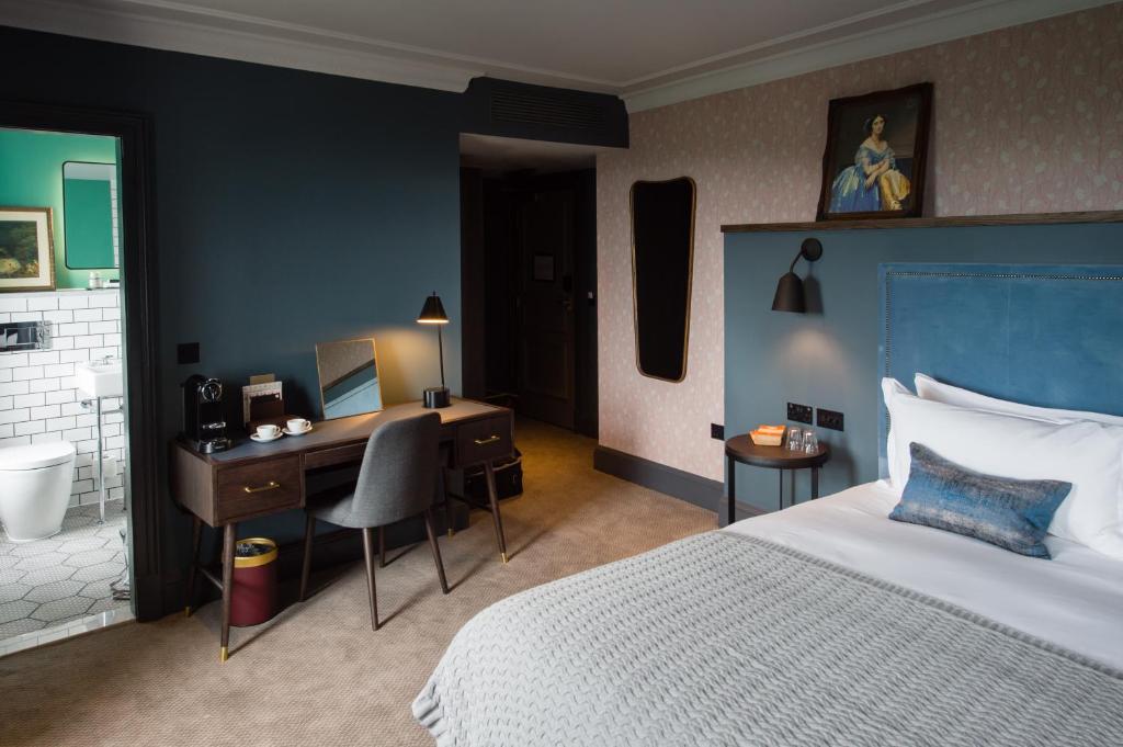 a bedroom with a bed and a desk with a computer at Avon Gorge by Hotel du Vin in Bristol