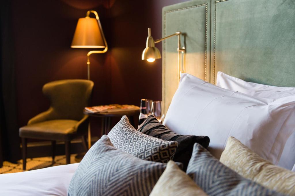 a bedroom with a bed with pillows and a chair at Avon Gorge by Hotel du Vin in Bristol