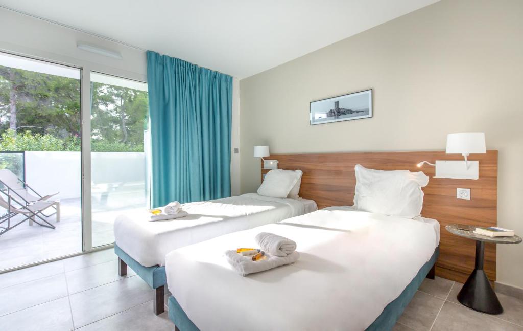 Postel nebo postele na pokoji v ubytování SOWELL HOTELS La Plage