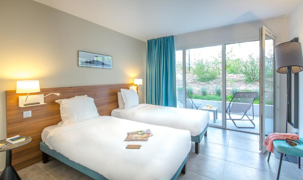 Postel nebo postele na pokoji v ubytování SOWELL HOTELS La Plage